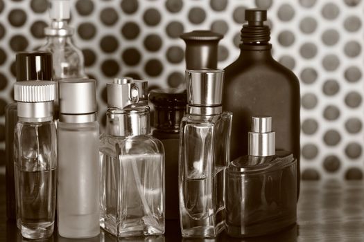 Perfume bottles in sepia color with tiles background
