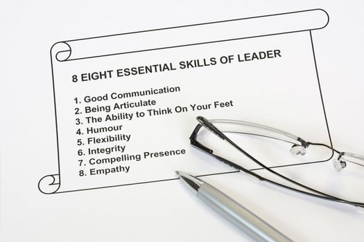 eight essential skills of leader concept with pen and eyeglass in whte background