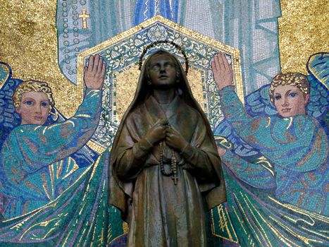 Mosaic of St Bernadette and the Virgin Mary outside the Basilica of the Rosary in Lourdes