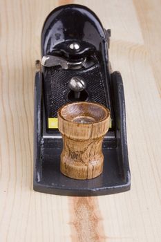 Woodworking handplane on a piece of wood.