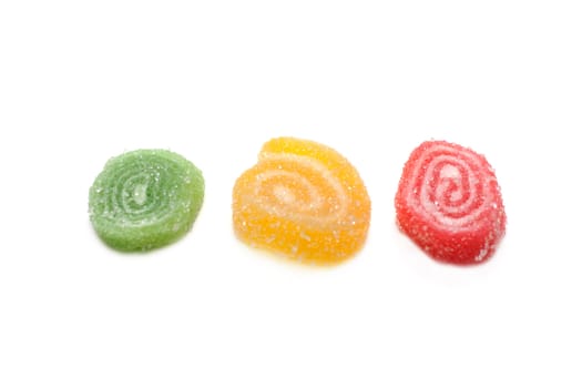 Colour fruit jellies in sugar on white background