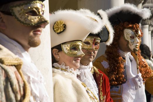 Traditionally dressed Venice carnival performers group in Piazza San Marco, Italy