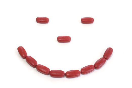 A smile made from multi-vitamin tablets.