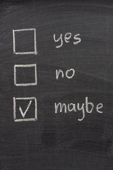 yes, no and maybe (checked) votting check boxes sketched with white chalk on blackboard, uncertainty or hesitation concept