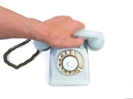 Man hand putting the handset of the old blue phone against the white background