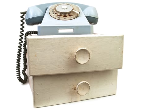 old phone at drawers against the white background