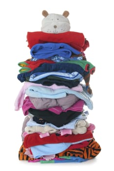 Huge pile (height 1 meter) made of children's textile clothes. Isolated on white background