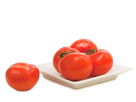 red tomatoes vine in plate against the white background