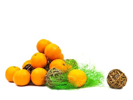 mandarines and golden balls with green against the white background