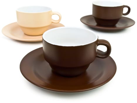 brown and beige coffee cups over the white background