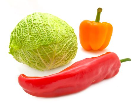 red pepper, orange paprika  and green cabbage over the white