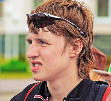Portrait of the young sportsman in dark glasses