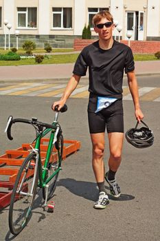 triathlon  competition participant with  green bicycle