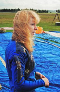 The girl in blue overalls, light hair flutter a wind
