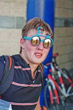 Portrait of the young sportsman bicyclist in mirror glasses