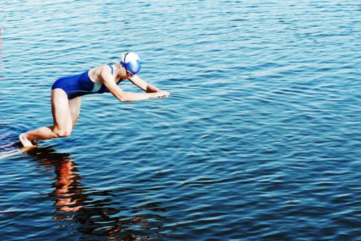 The sportswoman jumps in water at competitions