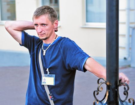 Portrait of the young man-artist  on city street