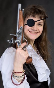 Girl - pirate with pistol in hand and eye patch on face