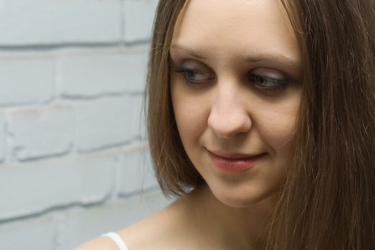 portrait of a smiling young pretty girl with long hair