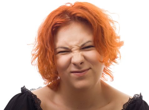 pretty girl with red hair is grimacing and smile