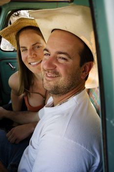 Portrait of Cowboy and woman in pickup truck cab