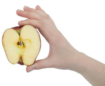 Cut apple in a female hand on white background