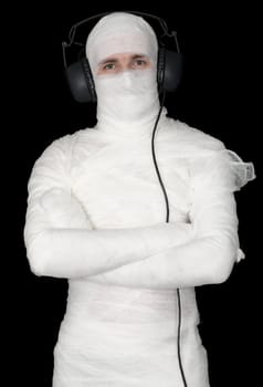 Man in bandage with ear-phones on black