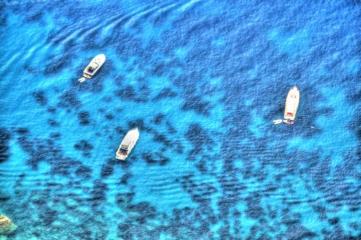 Yachts off the island of Capri and processed to appear as if they were in a painting.