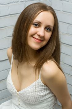 smiling cute girl in a white dress