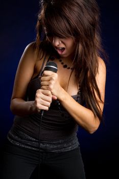 Rockstar girl singing holding microphone