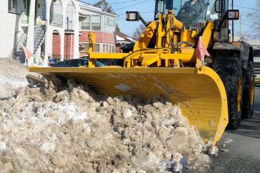 Snowplow clearing the street in a city