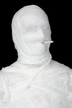 Mummy with cigarette on the black background
