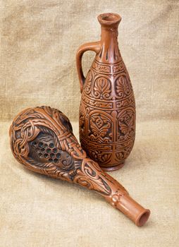 Two ceramic brown bottles on sacking background