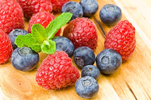 Fresh ripe blueberry, ruspberry and mint leaves