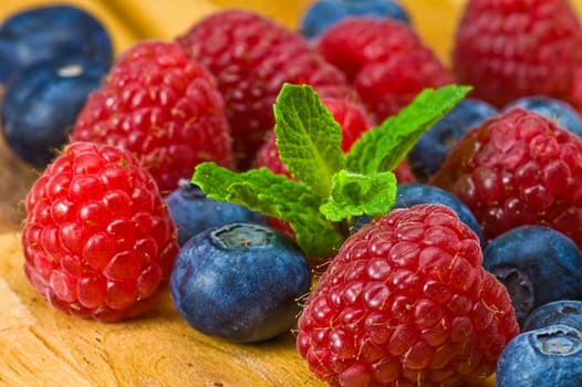 Fresh ripe blueberry, ruspberry and mint leaves