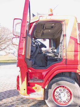 Drivers side door opening of a big  red truck