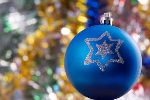 Blue sphere with brightly snowflake on the colored background