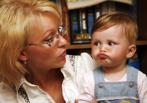 Portrait of the little girl with mum at home