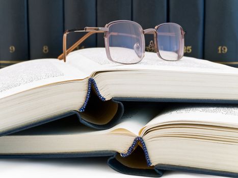 books and glasses against the book shelf