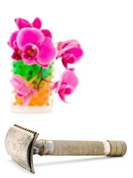 old fashioned shave razor and orchid in glass with hydrogel 