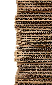 Stacked corrugated cardboard closeup, isolated on white.