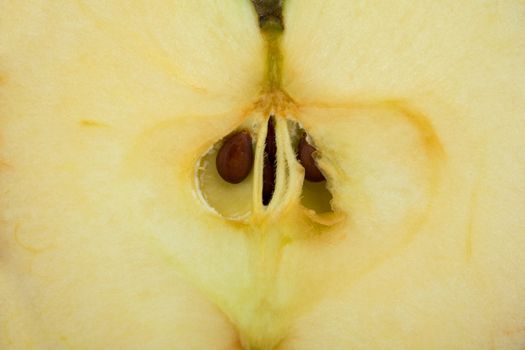 The cut sweet yellow apple - fruit background