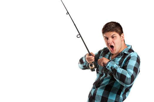 A teenager is surprised as he reels in a big fish.  Isolated over white in studio with plenty of negative space.