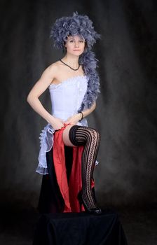 Portrait of the sexy beautiful girl with a boa on a head