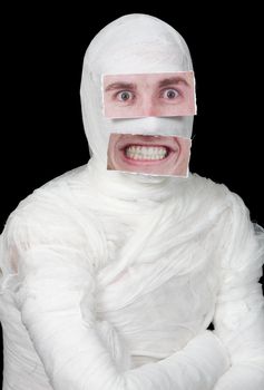 Bandaged man with false paper face on black