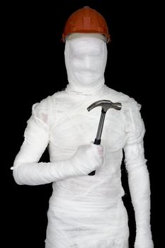 Laborer in bandages with helmet and hammer on black