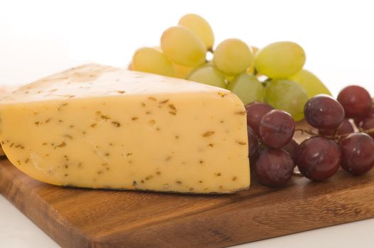 Flavorful hard cheese served with fresh grapes.