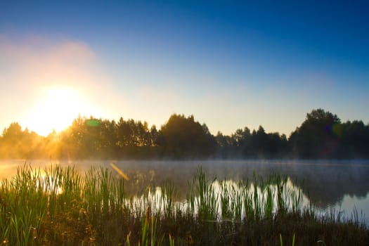 sunrise over lake with fog