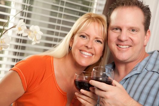 Happy Couple Enjoying a Glass of Wine the Kitchen.