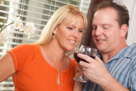 Happy Couple Enjoying a Glass of Wine the Kitchen.